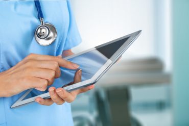 Doctor at hospital working with tablet